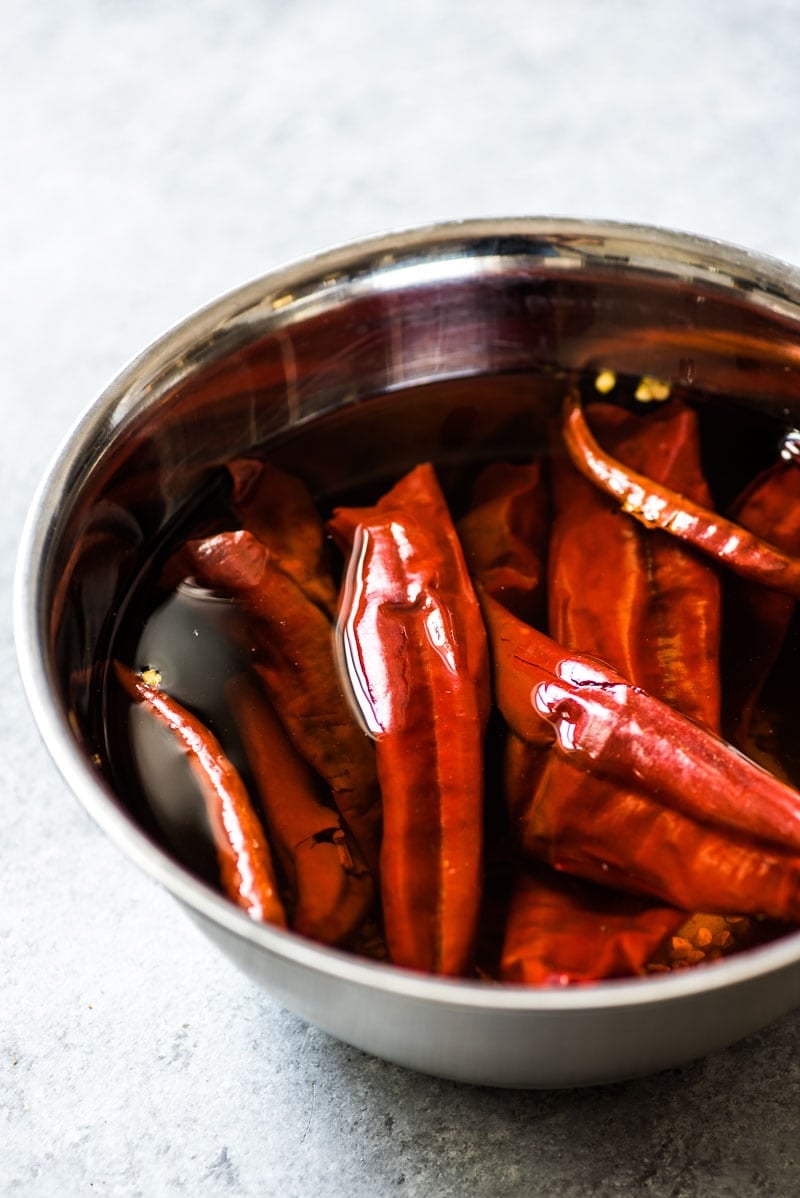 Guajillo peppers and chile de arbol peppers soaking for Camarones a la Diabla.