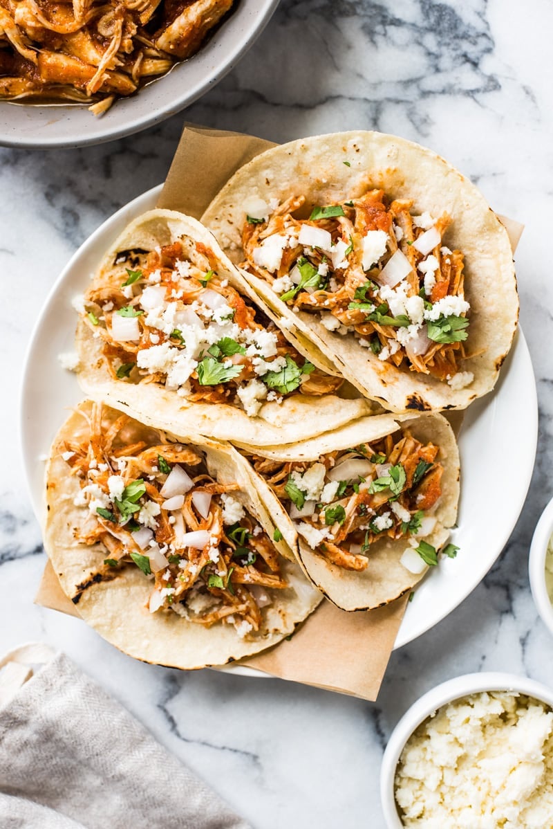 These Easy Chicken Tinga Tacos feature shredded chicken in a smoky chipotle sauce that's ready in only 30 minutes! (gluten free, low carb, paleo)