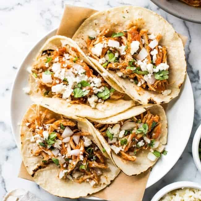 These Easy Chicken Tinga Tacos feature shredded chicken in a smoky chipotle sauce that's ready in only 30 minutes! (gluten free, low carb, paleo)