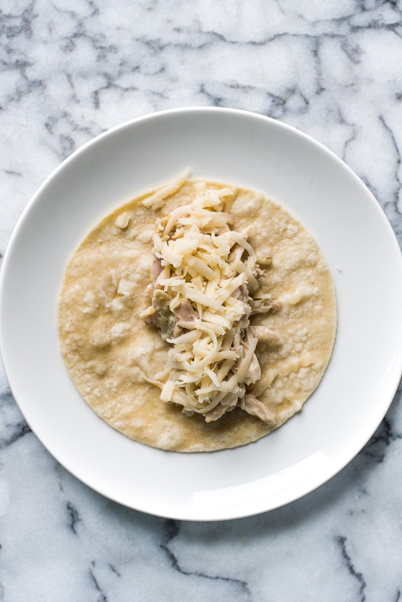 Enchiladas Suizas - enchiladas filled with shredded chicken and cheese and covered with an addicting salsa verde cream sauce. Simply the best!