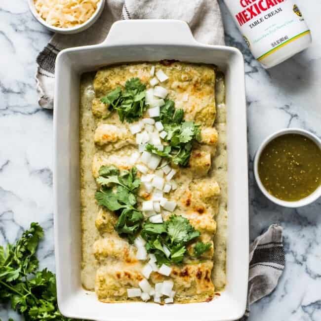 Enchiladas Suizas – enchiladas filled with shredded chicken and cheese and covered with an addicting salsa verde cream sauce. Simply the best!