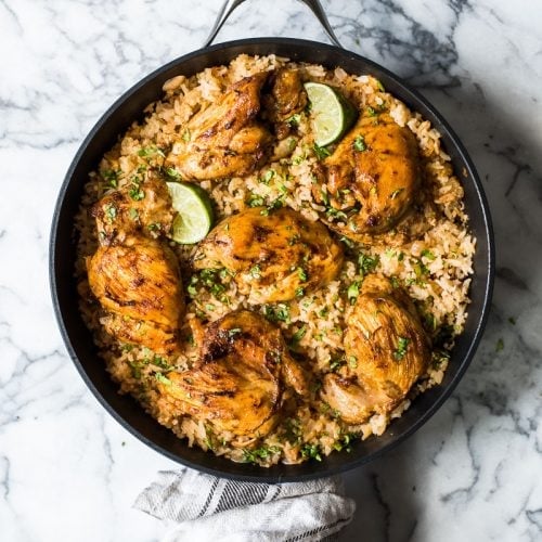 This Mexican Chicken and Rice features tender, juicy marinated chicken thighs and authentic Mexican rice cooked all in one pot!