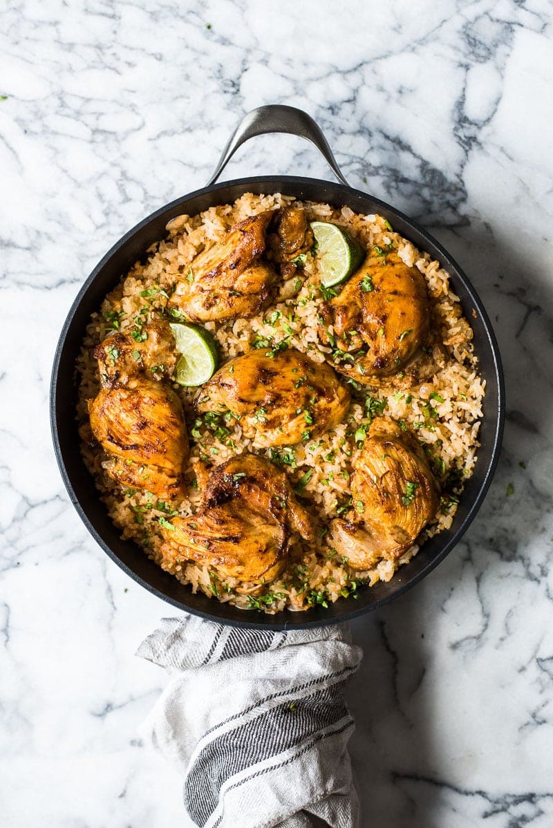 This Mexican Chicken and Rice features tender, juicy marinated chicken thighs and authentic Mexican rice cooked all in one pot!