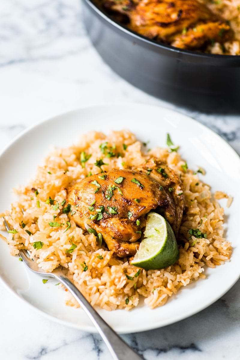 This Mexican Chicken and Rice bake features tender, juicy marinated chicken thighs and authentic Mexican rice cooked all in one pot!