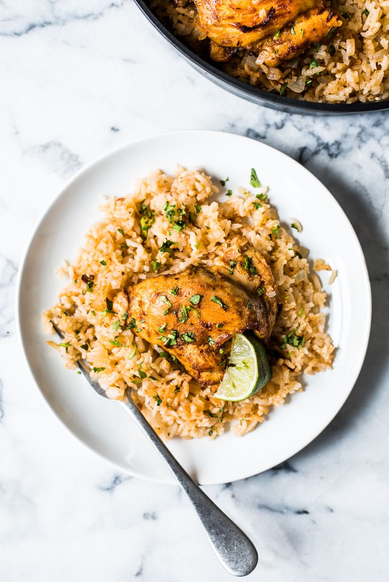 This Mexican Chicken and Rice recipe features tender, juicy marinated chicken thighs and authentic Mexican rice cooked all in one pot!