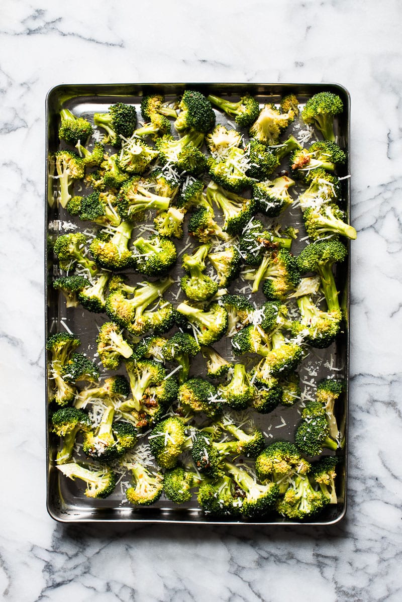 Ready in only 15 minutes, this Roasted Broccoli is tossed in a chili garlic sauce and topped with Parmesan cheese for a healthy and delicious veggie side dish!