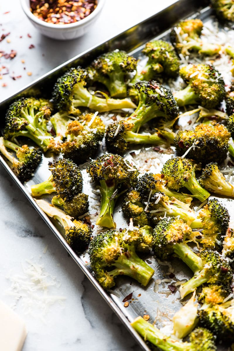 Ready in only 15 minutes, this Roasted Broccoli is tossed in a chili garlic sauce and topped with Parmesan cheese for a healthy and delicious veggie side dish!