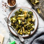 Ready in only 15 minutes, this Roasted Broccoli is tossed in a chili garlic sauce and topped with Parmesan cheese for a healthy and delicious veggie side dish!