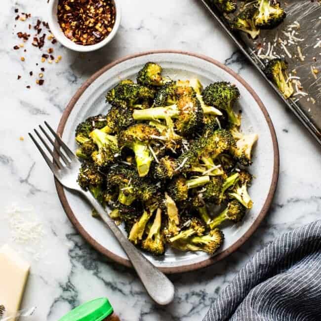 Ready in only 15 minutes, this Roasted Broccoli is tossed in a chili garlic sauce and topped with Parmesan cheese for a healthy and delicious veggie side dish!