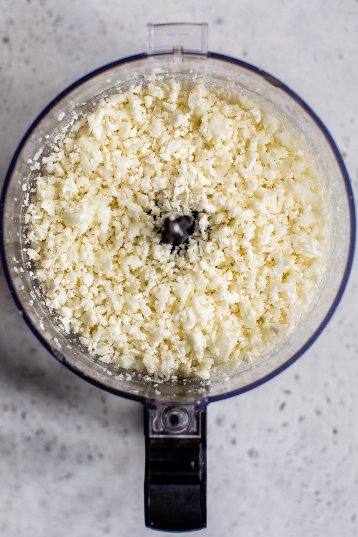 Riced cauliflower in a food processor.