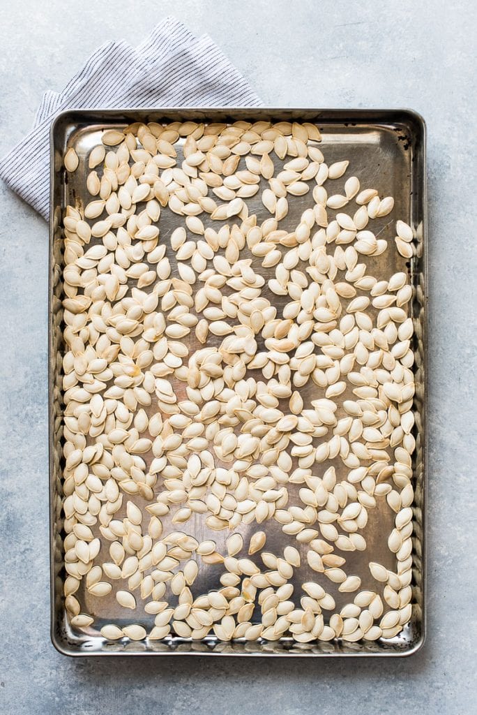 Pumpkin seeds on a baking sheet