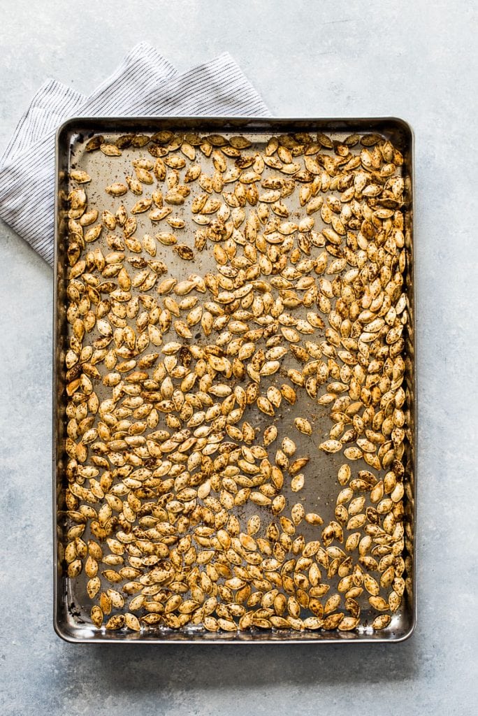 Roasted pumpkin seeds on a baking sheets