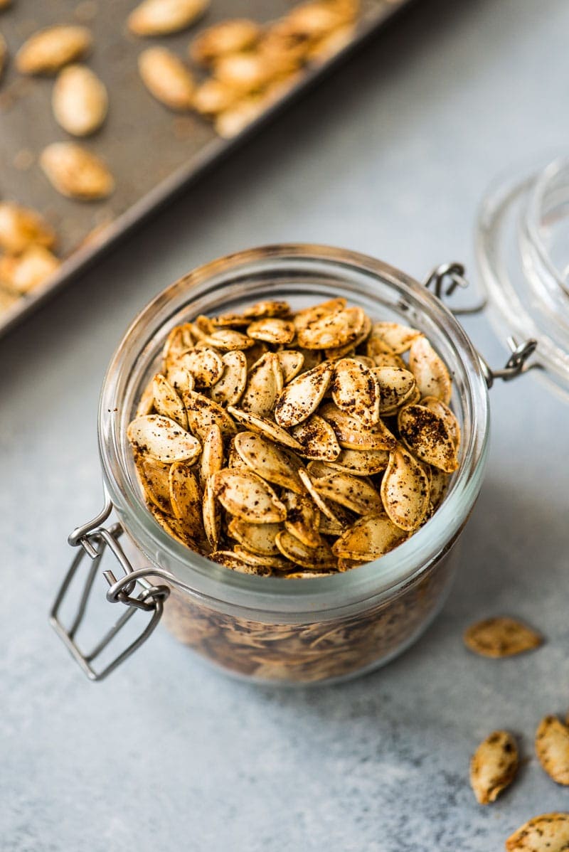 Roasted pumpkin seeds in a glass jar