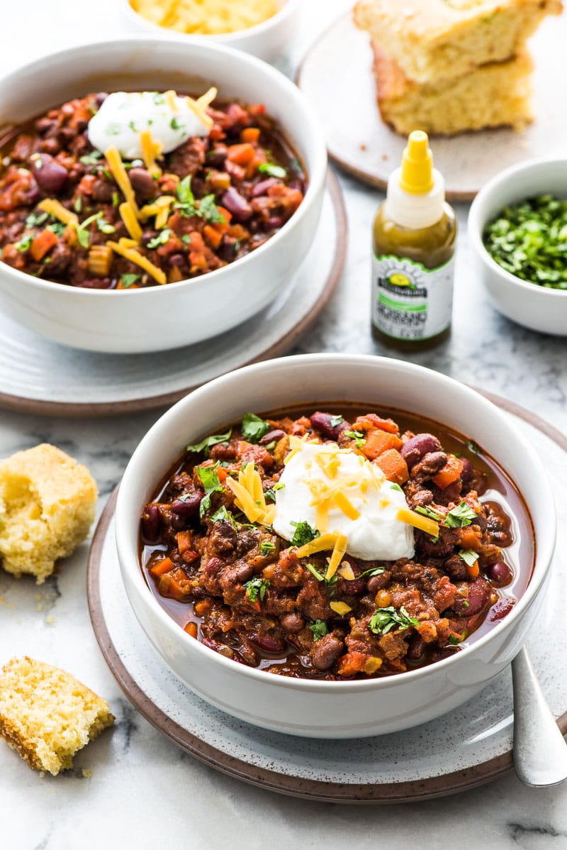 This Spicy Vegetarian Chili is thick, satisfying and super filling! Serve it with your favorite toppings for an easy and healthy meatless meal. (gluten free, vegetarian, vegan) Featuring Yellowbird hot sauce and served with jalapeno cornbread.