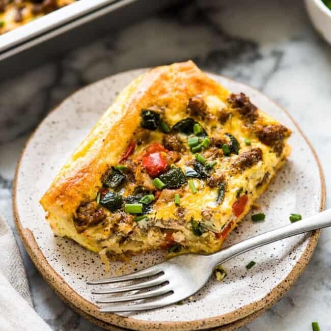 This Tex Mex Sausage Breakfast Casserole is made with crescent roll dough, breakfast sausage, peppers and onions. It's perfect for brunch and can be made ahead of time!