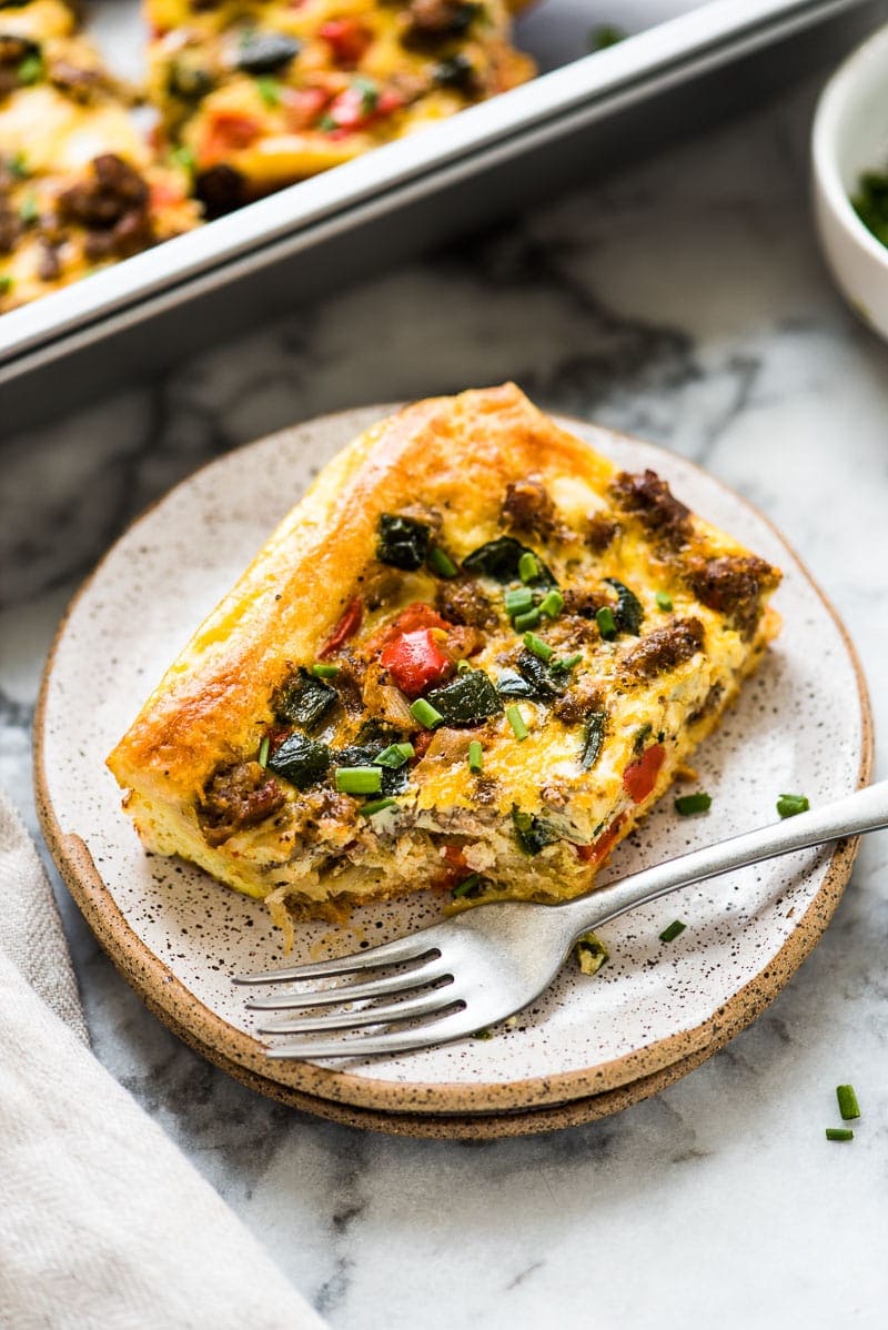 This Tex Mex Sausage Breakfast Casserole is made with crescent roll dough, breakfast sausage, peppers and onions. It's perfect for brunch and can be made ahead of time!