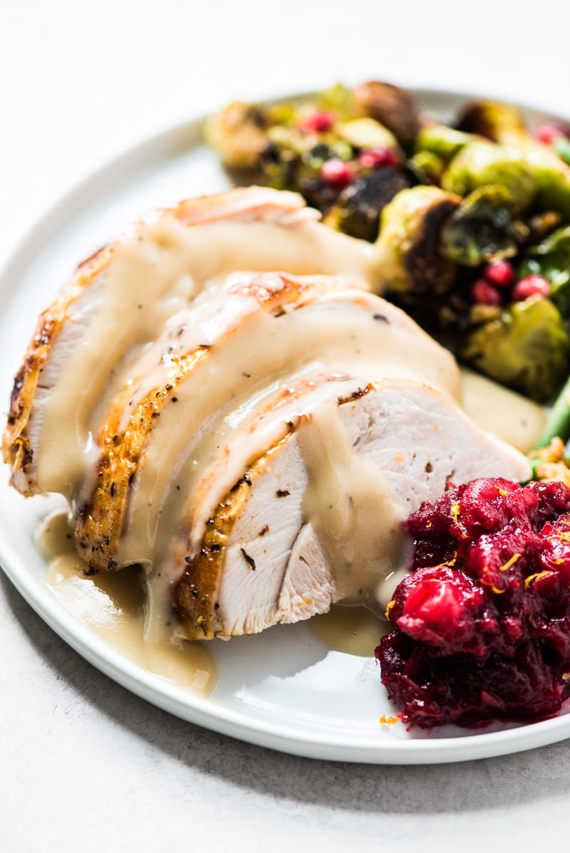 A Thanksgiving dinner plate with a side of cranberry sauce recipe.