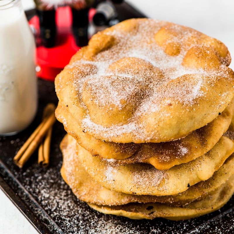 Bunuelos covered with cinnamon sugar.