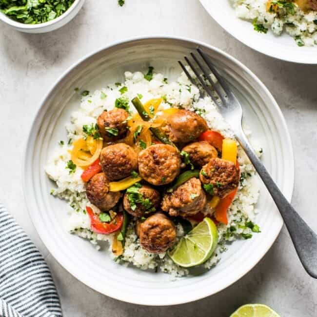 This Healthy Turkey Fajita Rice Bowl recipe is made with delicious cilantro lime cauliflower rice, savory peppers and onions and spicy turkey! (low carb, gluten free, paleo)