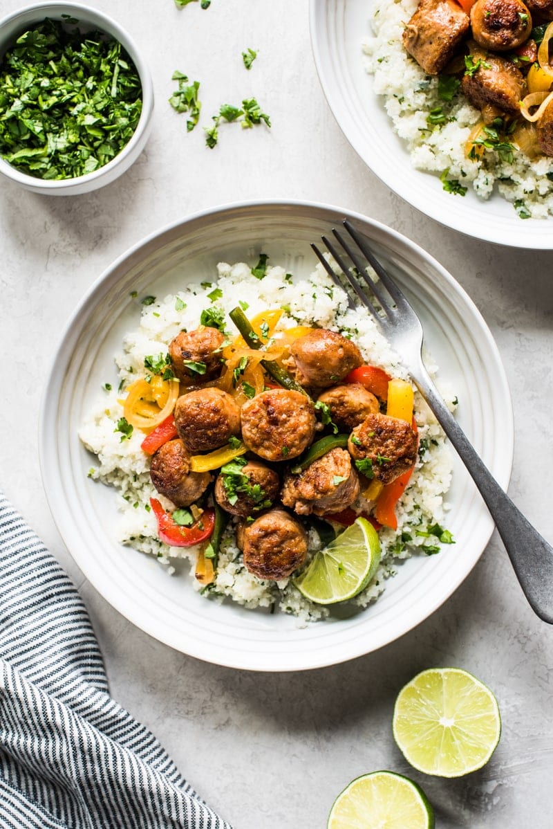 This Healthy Turkey Fajita Rice Bowl recipe is made with delicious cilantro lime cauliflower rice, savory peppers and onions and spicy turkey! (low carb, gluten free, paleo)