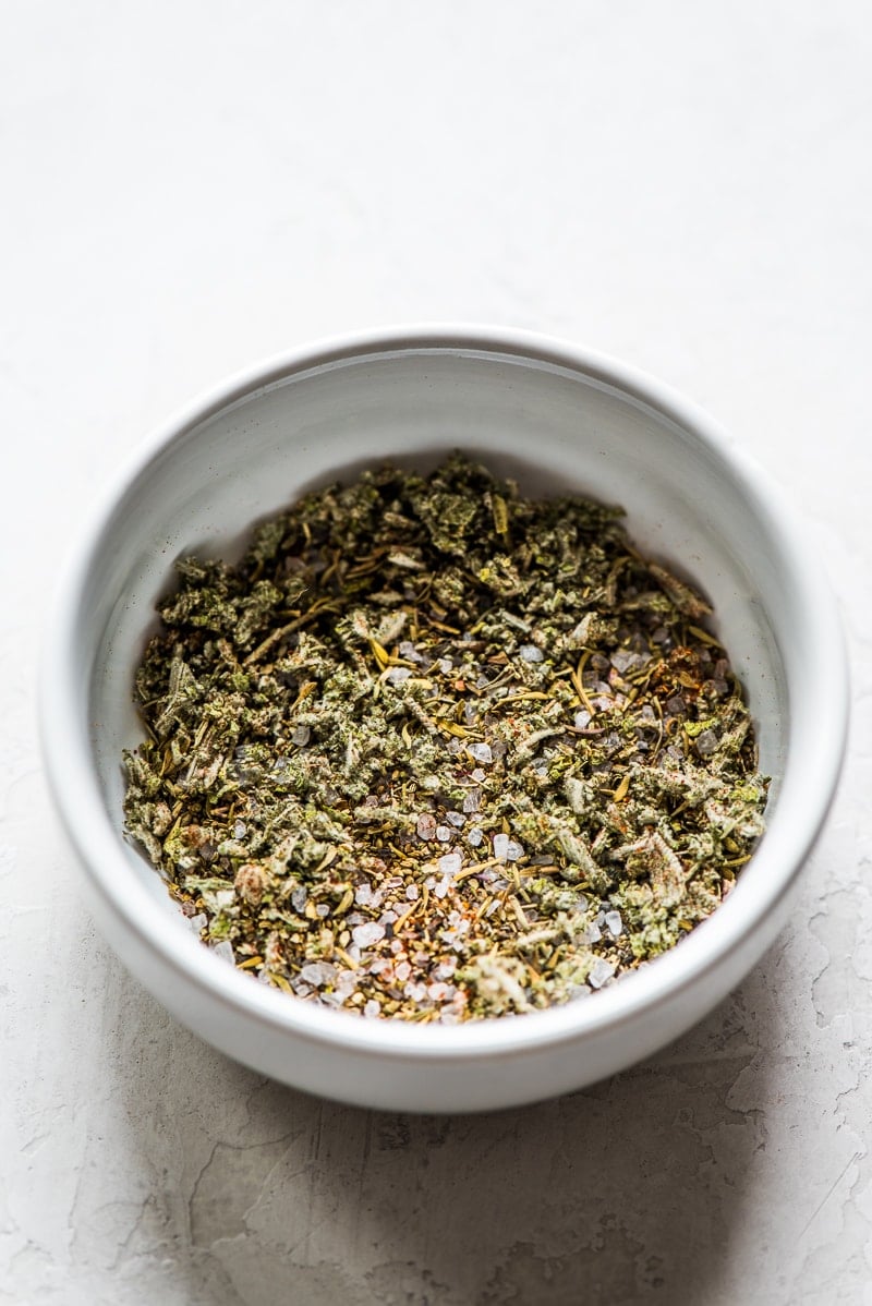 Herbs and spices for butternut squash soup in a small white bowl