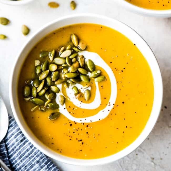 Roasted butternut squash soup in a white bowl.