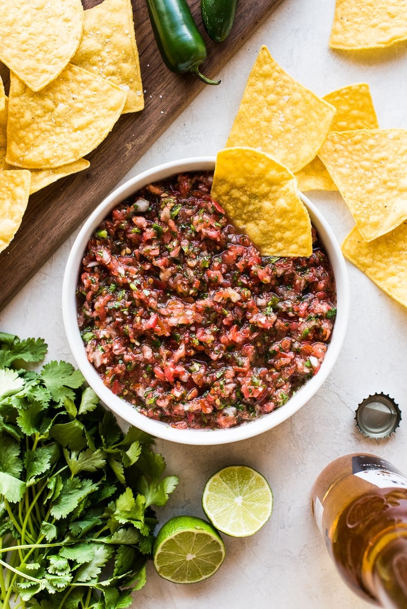 Fresh salsa recipe in a bowl ready to be eaten with tortilla chips.