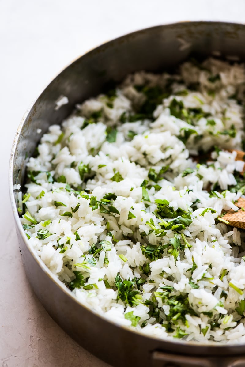 Cilantro Lime Rice in a pan topped with chopped cilantro.