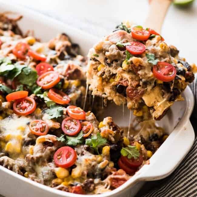 This Easy Taco Casserole (also known as Taco Lasagna) is made with 3 layers of corn tortillas, ground beef, corn, black beans, the best taco seasoning and lots of melted cheese!