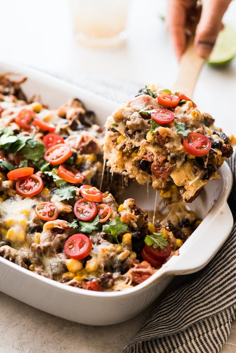 This Easy Taco Casserole (also known as Taco Lasagna) is made with 3 layers of corn tortillas, ground beef, corn, black beans, the best taco seasoning and lots of melted cheese!