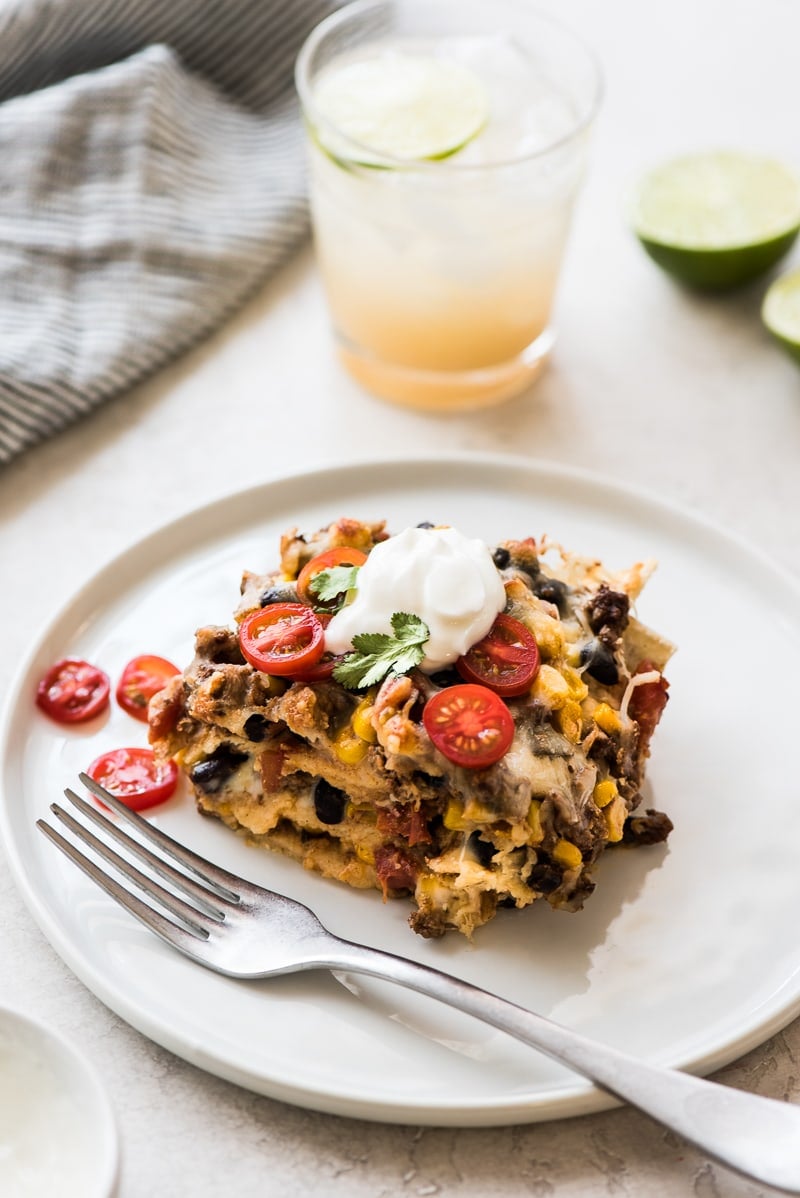 This Easy Taco Casserole (also known as Taco Lasagna) is made with 3 layers of corn tortillas, ground beef, corn, black beans, the best taco seasoning and lots of melted cheese!