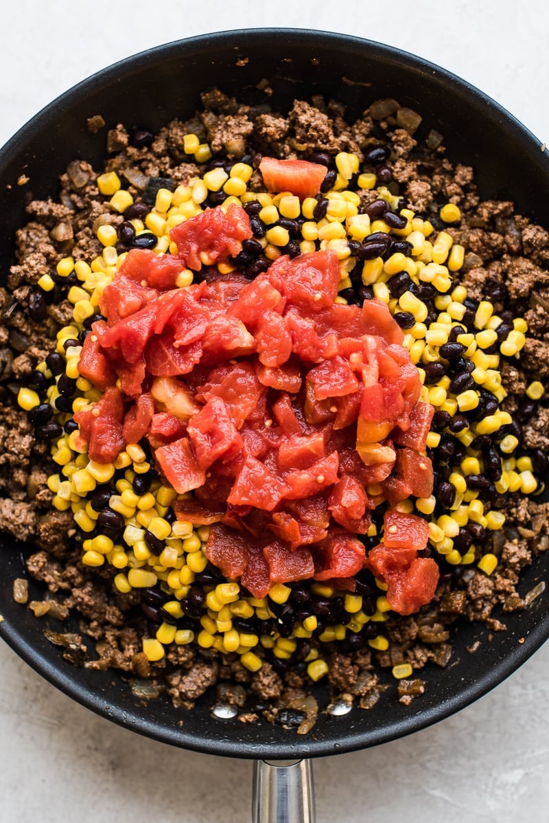 This Easy Taco Casserole (also known as Taco Lasagna) is made with 3 layers of corn tortillas, ground beef, corn, black beans, the best taco seasoning and lots of melted cheese!
