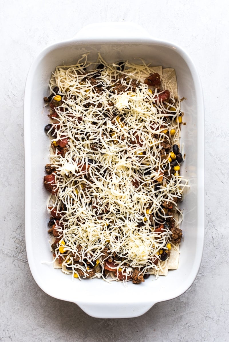 This Easy Taco Casserole (also known as Taco Lasagna) is made with 3 layers of corn tortillas, ground beef, corn, black beans, the best taco seasoning and lots of melted cheese!