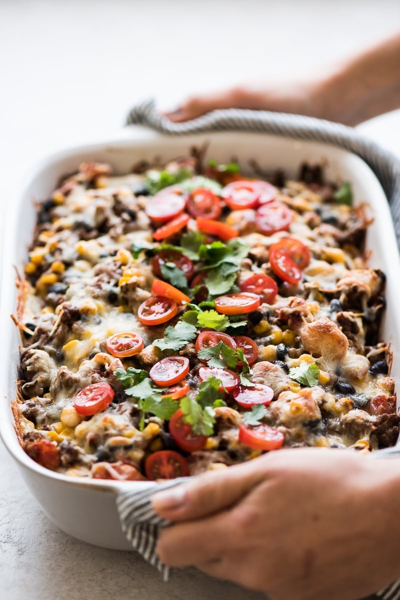 This Easy Taco Casserole (also known as Taco Lasagna) is made with 3 layers of corn tortillas, ground beef, corn, black beans, the best taco seasoning and lots of melted cheese!