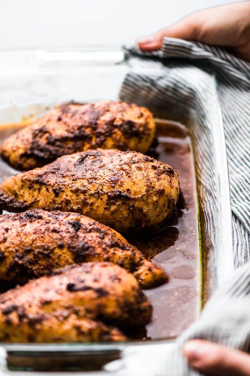 Chipotle chicken breasts in a baking dish. | If you love Chipotle Mexican Grill, you're going to love this copycat Chipotle Chicken Recipe! Made with a flavorful marinade and perfect for healthy meals!