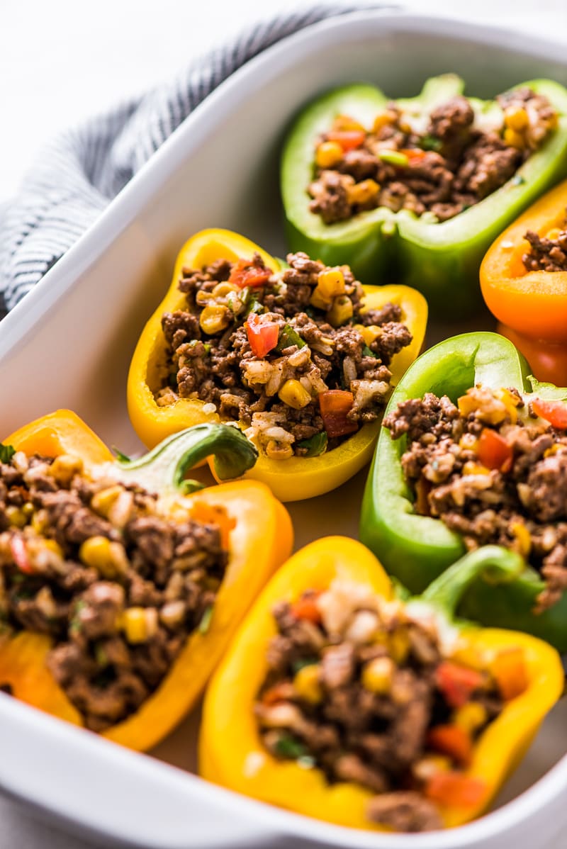 Easy Stuffed Peppers filled with ground beef, chicken or turkey and seasoned with an easy taco seasoning perfect for weeknight meals!