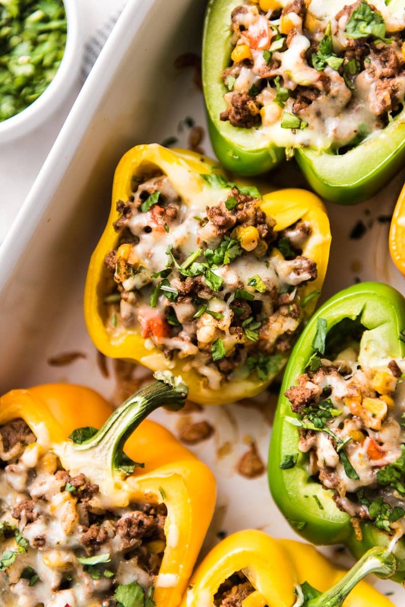 Mexican Stuffed Peppers filled with ground beef, chicken or turkey and seasoned with an easy taco seasoning perfect for weeknight meals!
