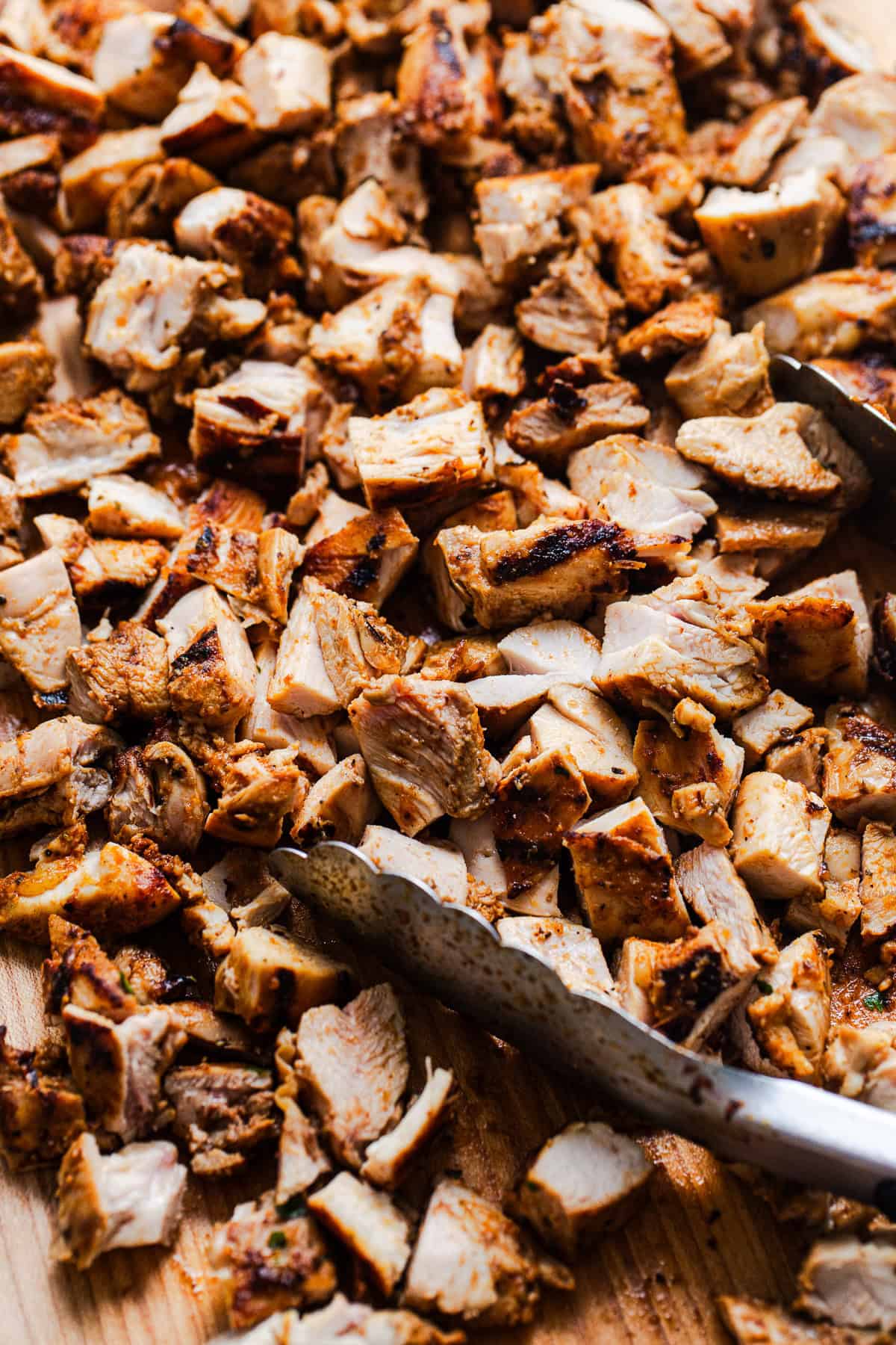 Copycat Chipotle chicken chopped into cubes on a cutting board.
