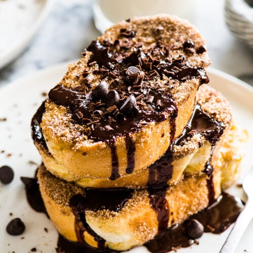 This Cinnamon French Toast is covered in cinnamon sugar and topped with a Mexican chocolate sauce. All the flavor of Mexican churros - but for breakfast!﻿
