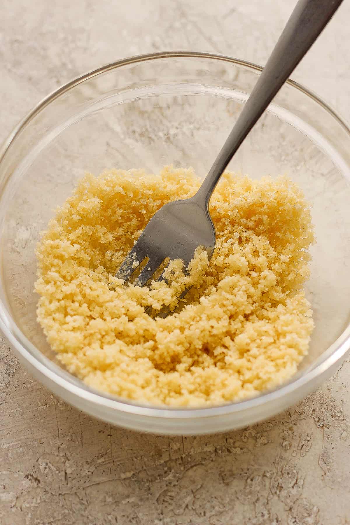 Crispy panko breadcrumbs mixed with melted butter in a bowl.