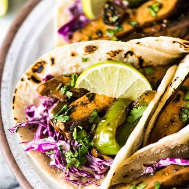 Mushroom tacos filled with marinated portabella mushrooms, bell peppers and red cabbage slaw