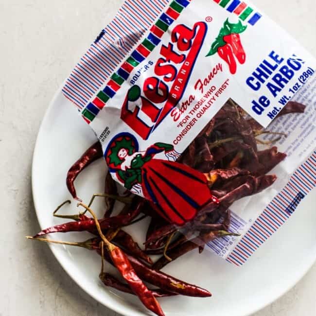 Chile de Arbol Peppers on a white plate.
