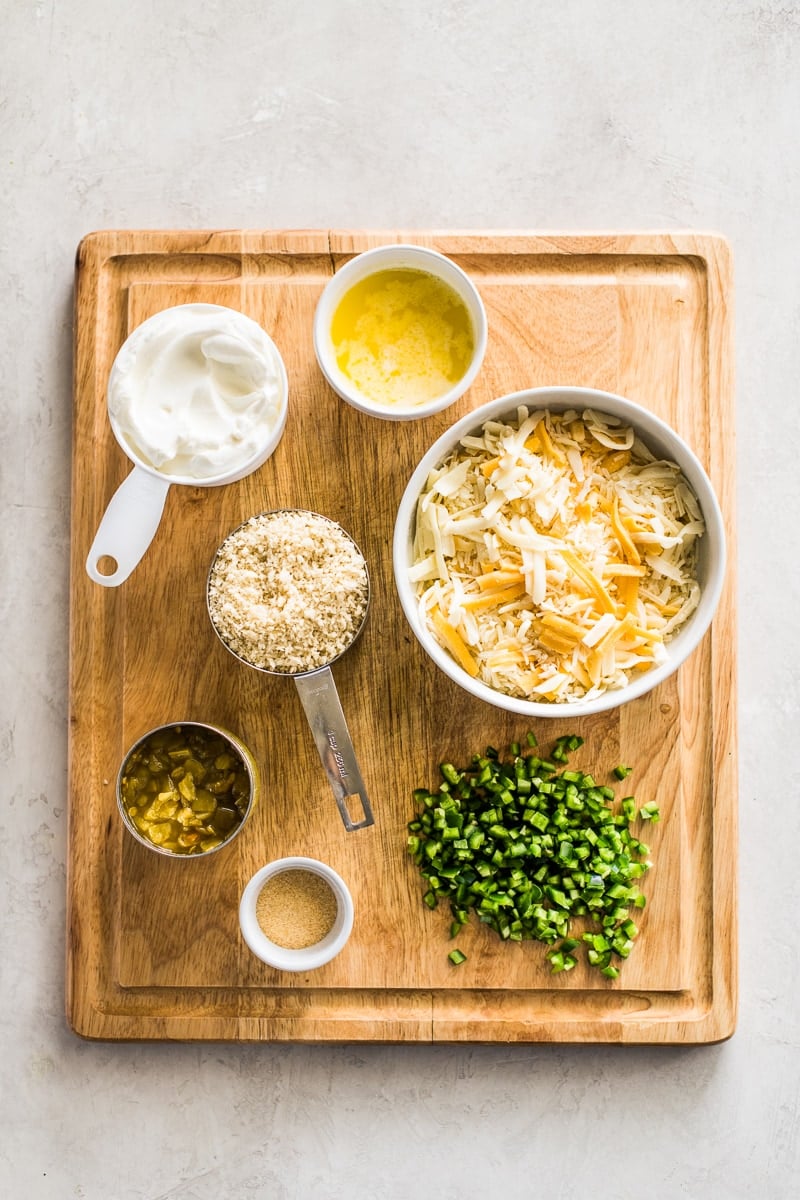 Ingredients for making the jalapeno popper dip recipe, including sour cream, shredded cheese, panko breadcrumbs, butter and more.