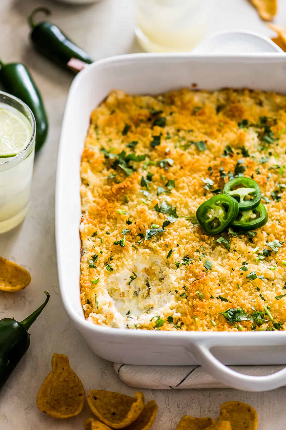 The best jalapeno popper dip with a scoop taken out to see the creamy inside.