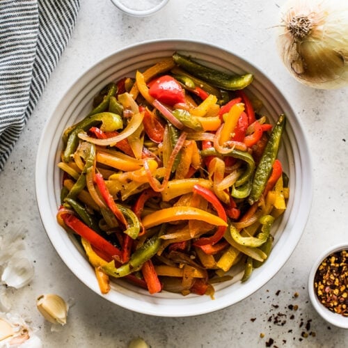 Sauteed Peppers and onions in a white bowl.