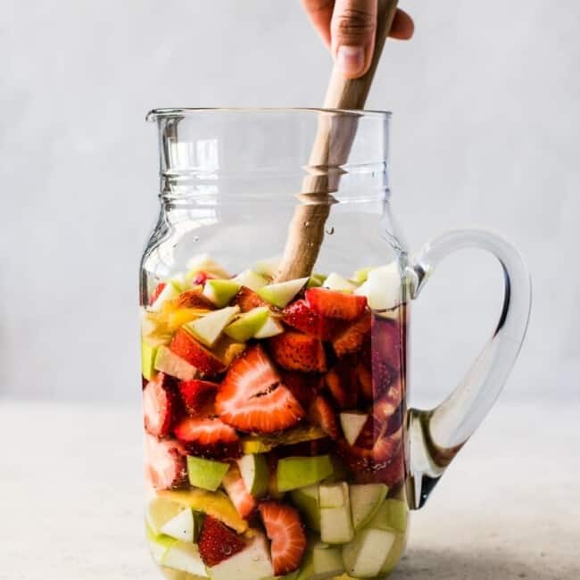 White sangria in a glass pitcher.