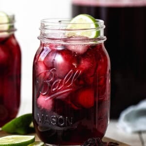 Agua de jamaica served in a glass with ice.