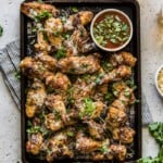 Grilled Garlic Parmesan Chicken Wings on a large serving platter topped with cilantro.