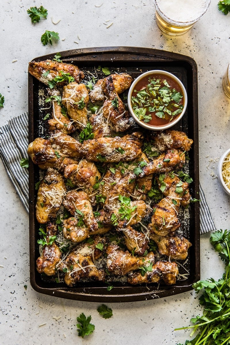 Grilled Garlic Parmesan Chicken Wings on a large serving tray topped with cilantro.