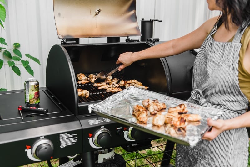 Isabel Orozco-Moore from Isabel Eats grilling wings on a Char-Griller Texas Trio grill.
